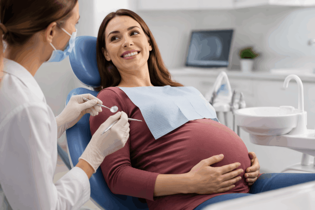 Pregnant woman receiving professional dental cleaning in a modern dental clinic